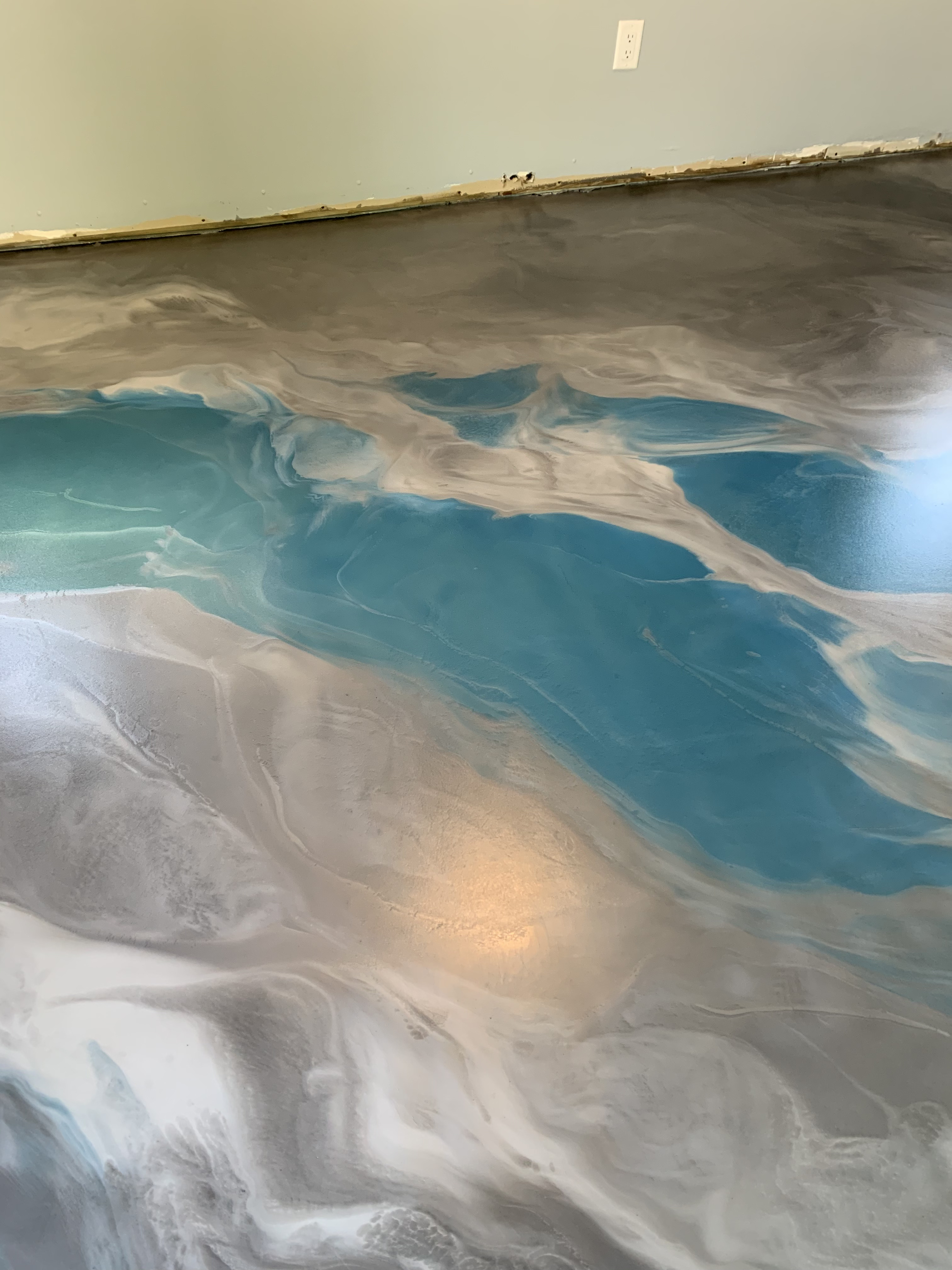 Blue and grey metallic epoxy flooring in a residential setting